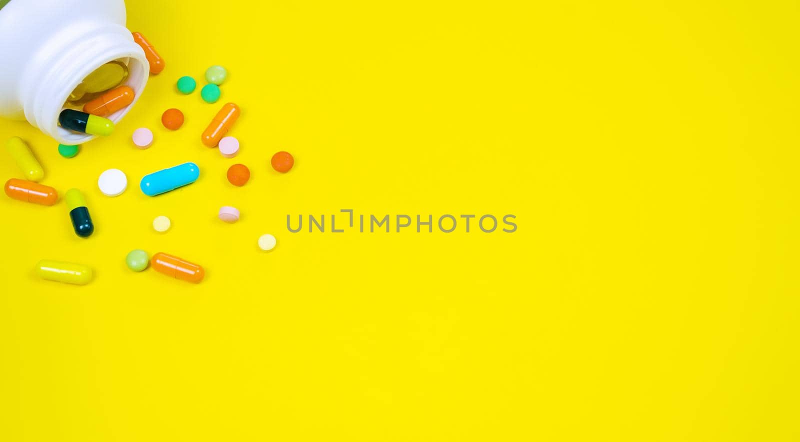 medicines, pills, mask, virus on a yellow background covid