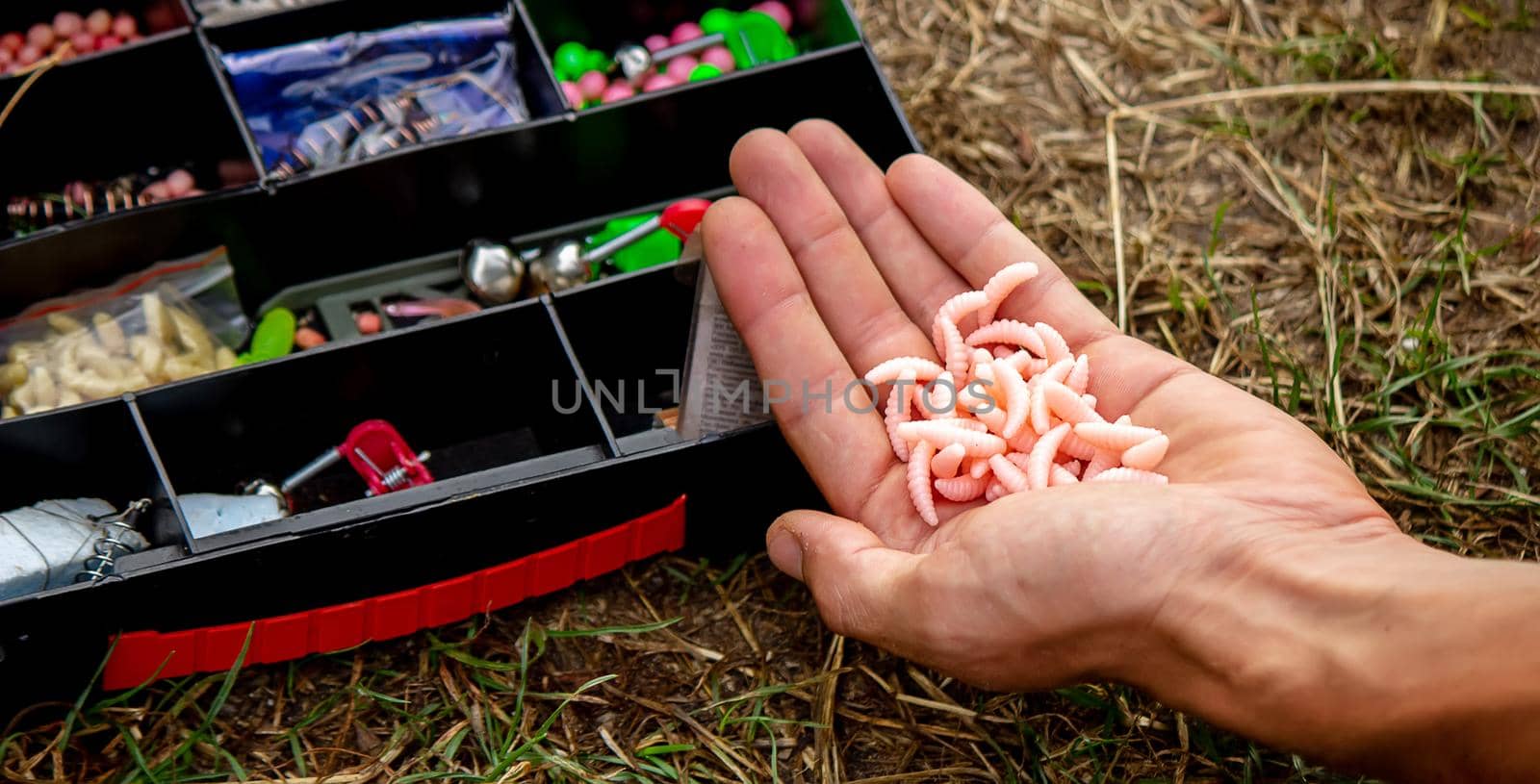 fishing tackle on a wooden float with mountain background and selective focus, nature