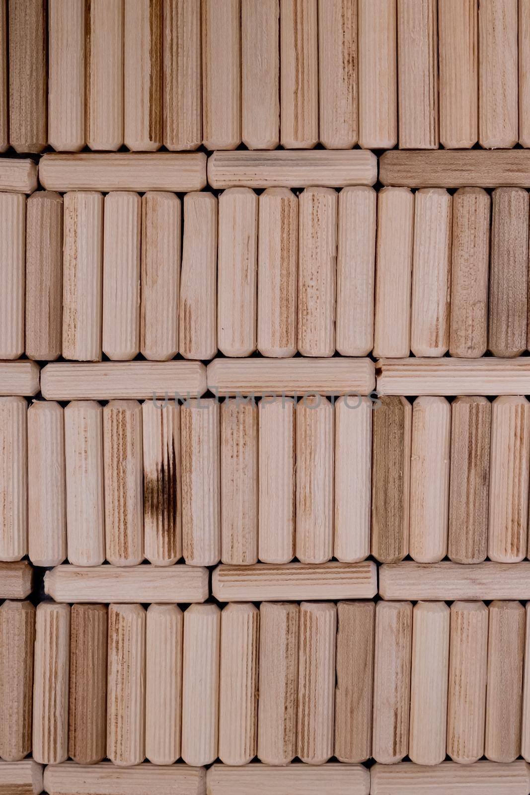 View of a grouping of wooden dowels as background. Close-up.