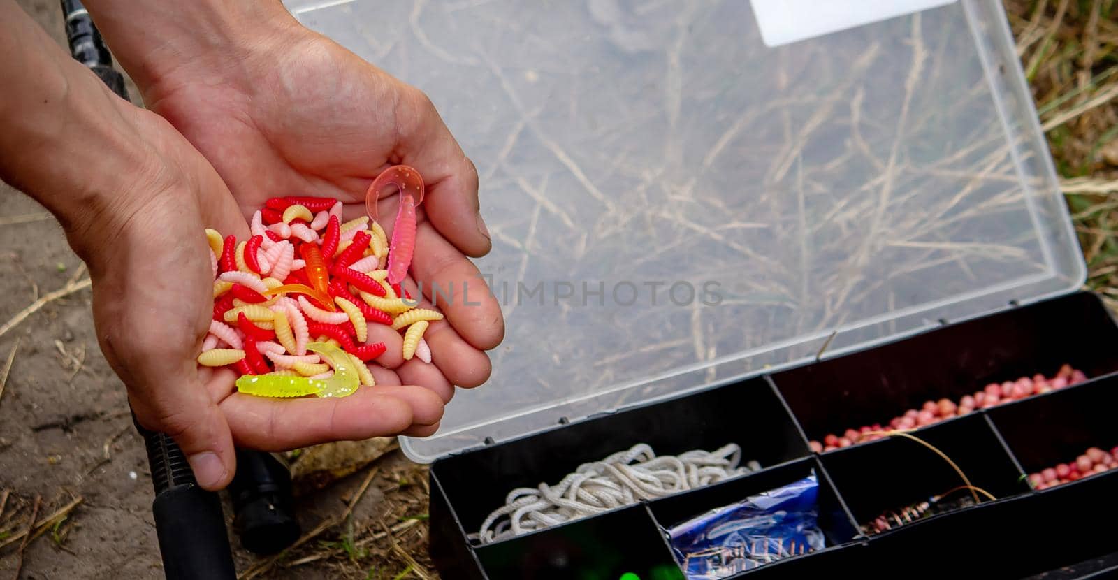 fishing tackle on a wooden float with mountain background and selective focus, nature