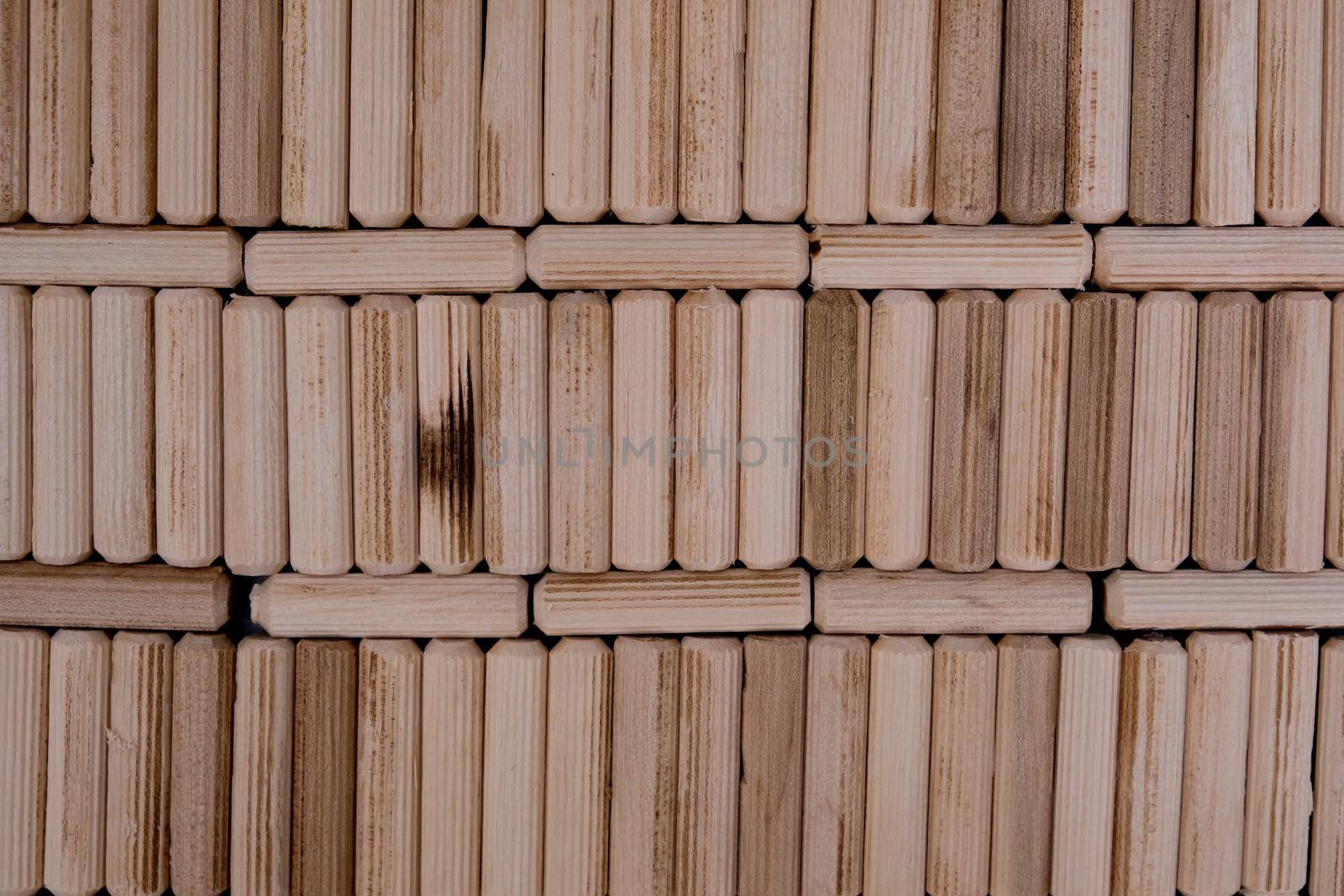 View of a grouping of wooden dowels as background. Close-up. by leonik