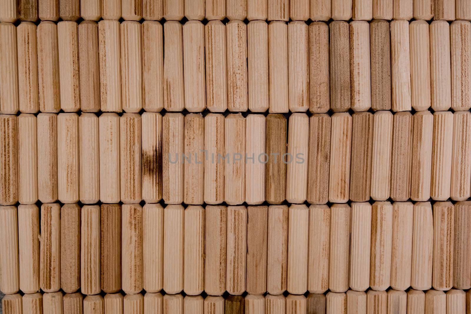 View of a grouping of wooden dowels as background. Close-up. by leonik