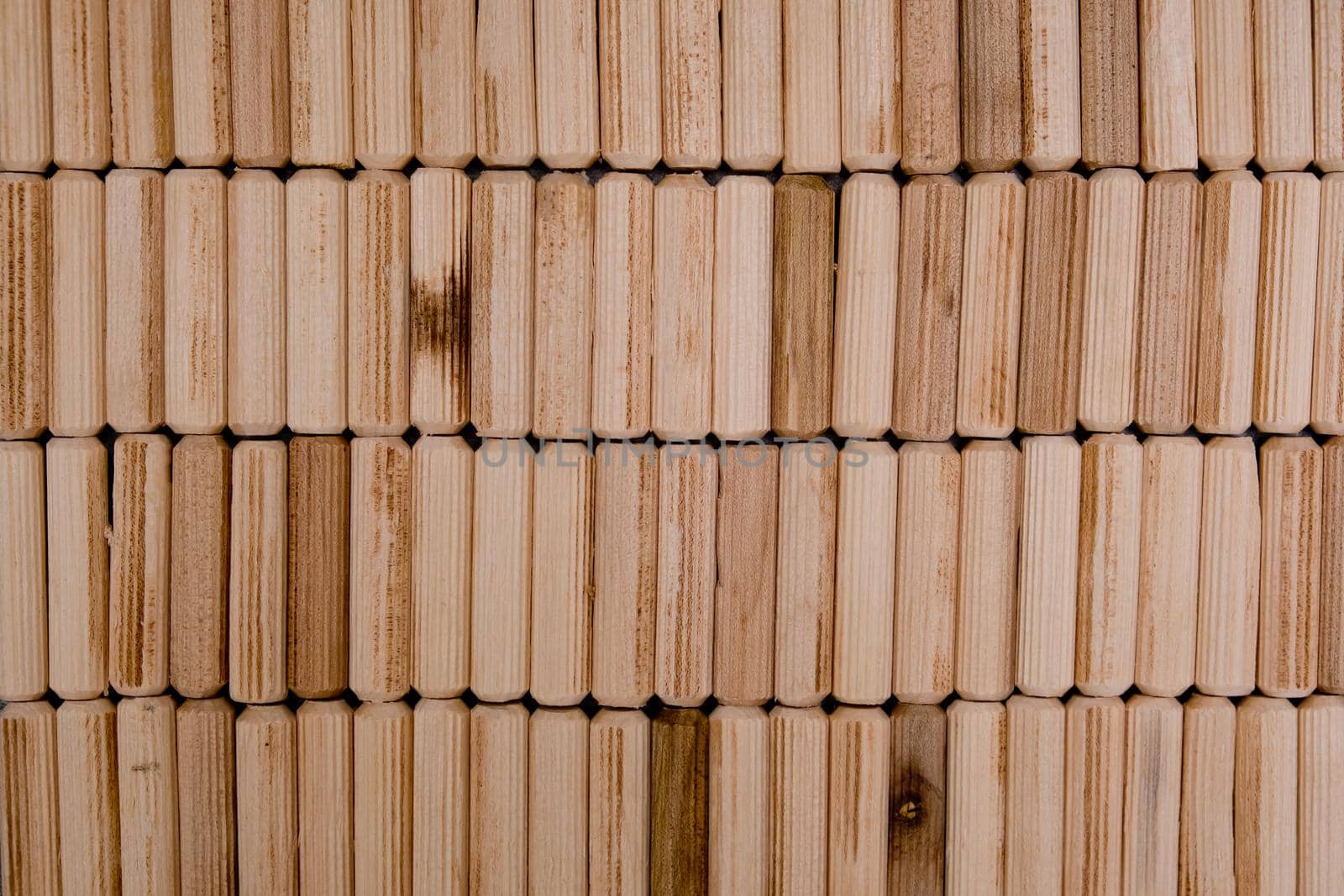 View of a grouping of wooden dowels as background. Close-up.