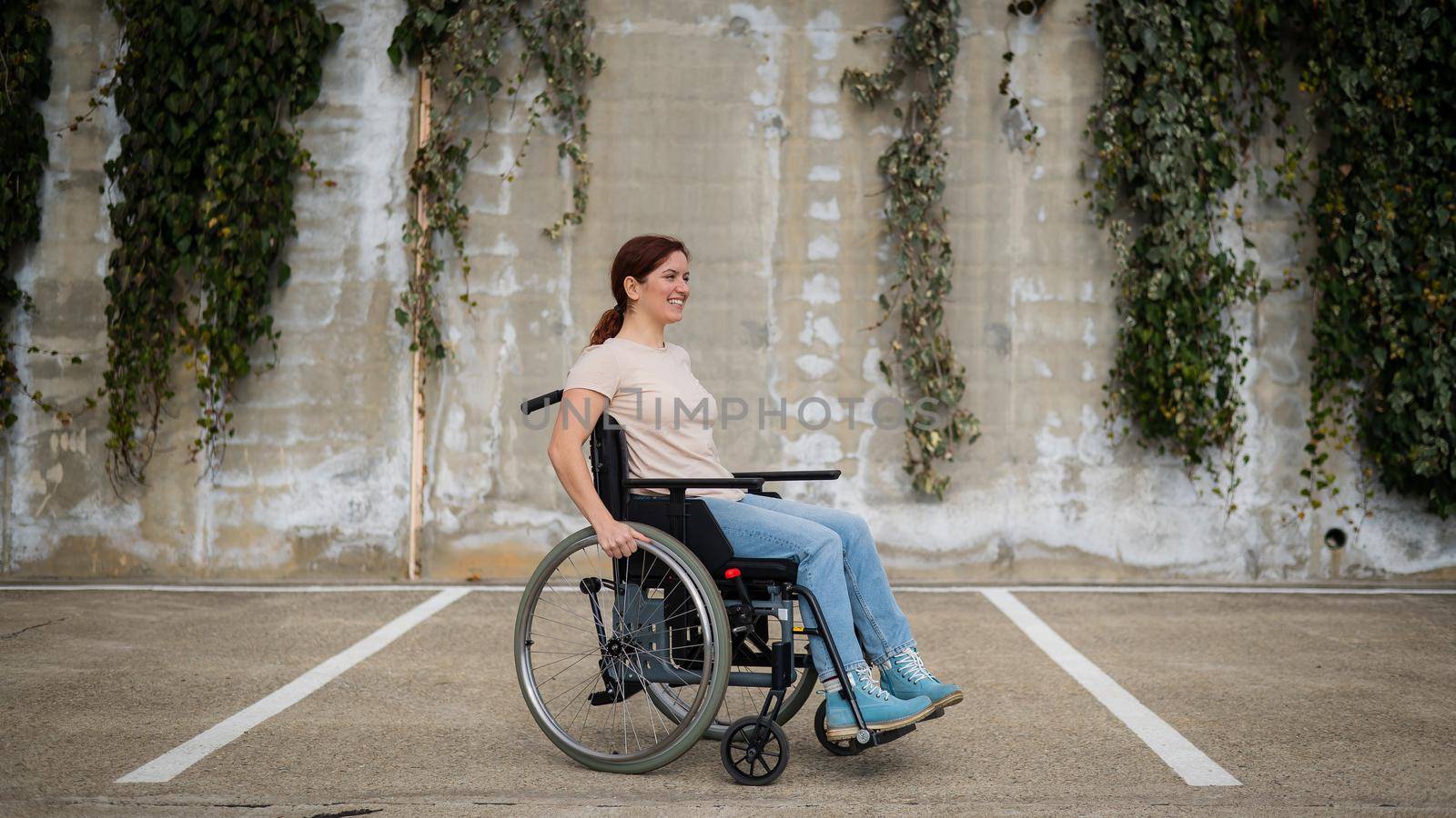 Woman riding a wheelchair in a parking lot