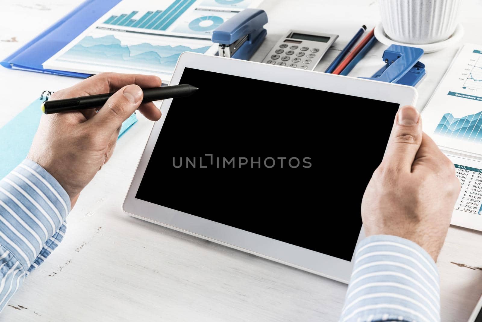 close-up of men's hands with a computer tablet. Businessman works in the office