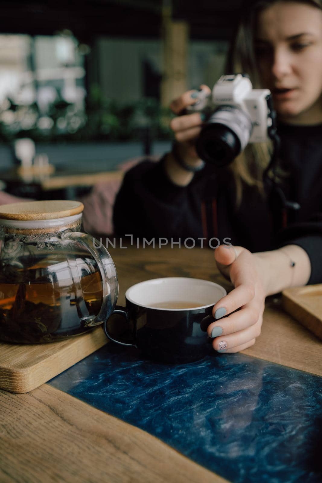 woman take photo of cup of tea. Selective focus by Symonenko