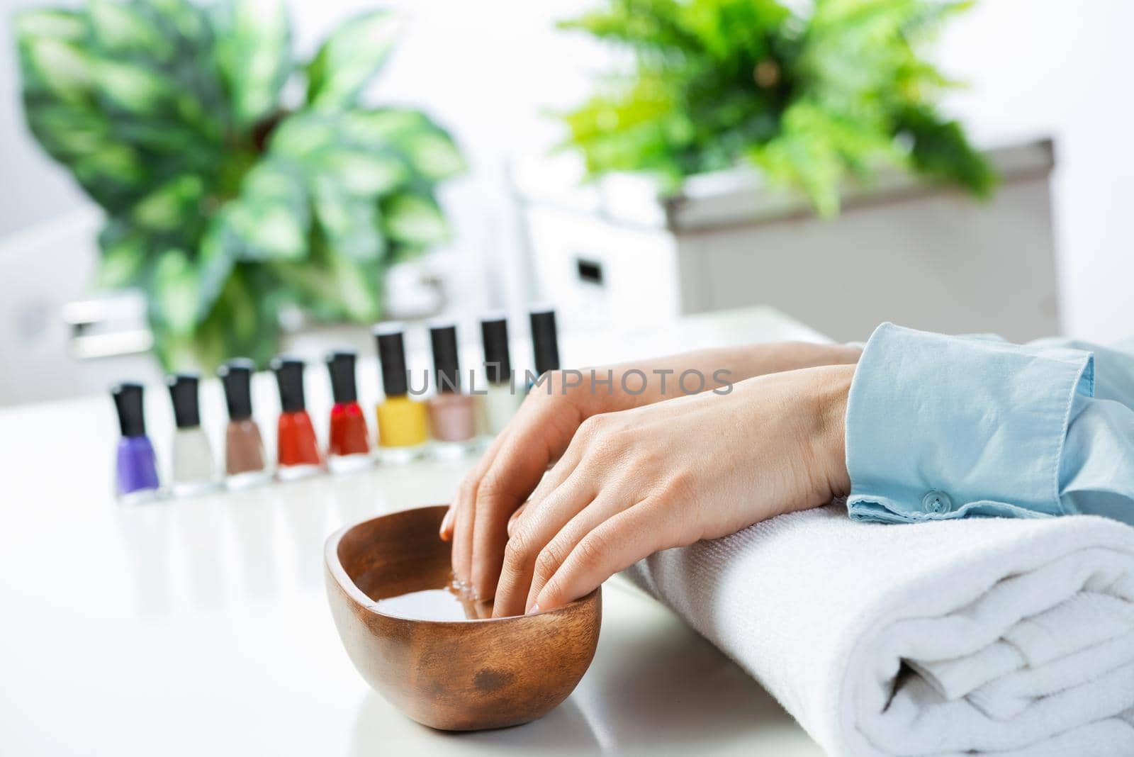 Closeup female hands in wooden bowl with water by adam121