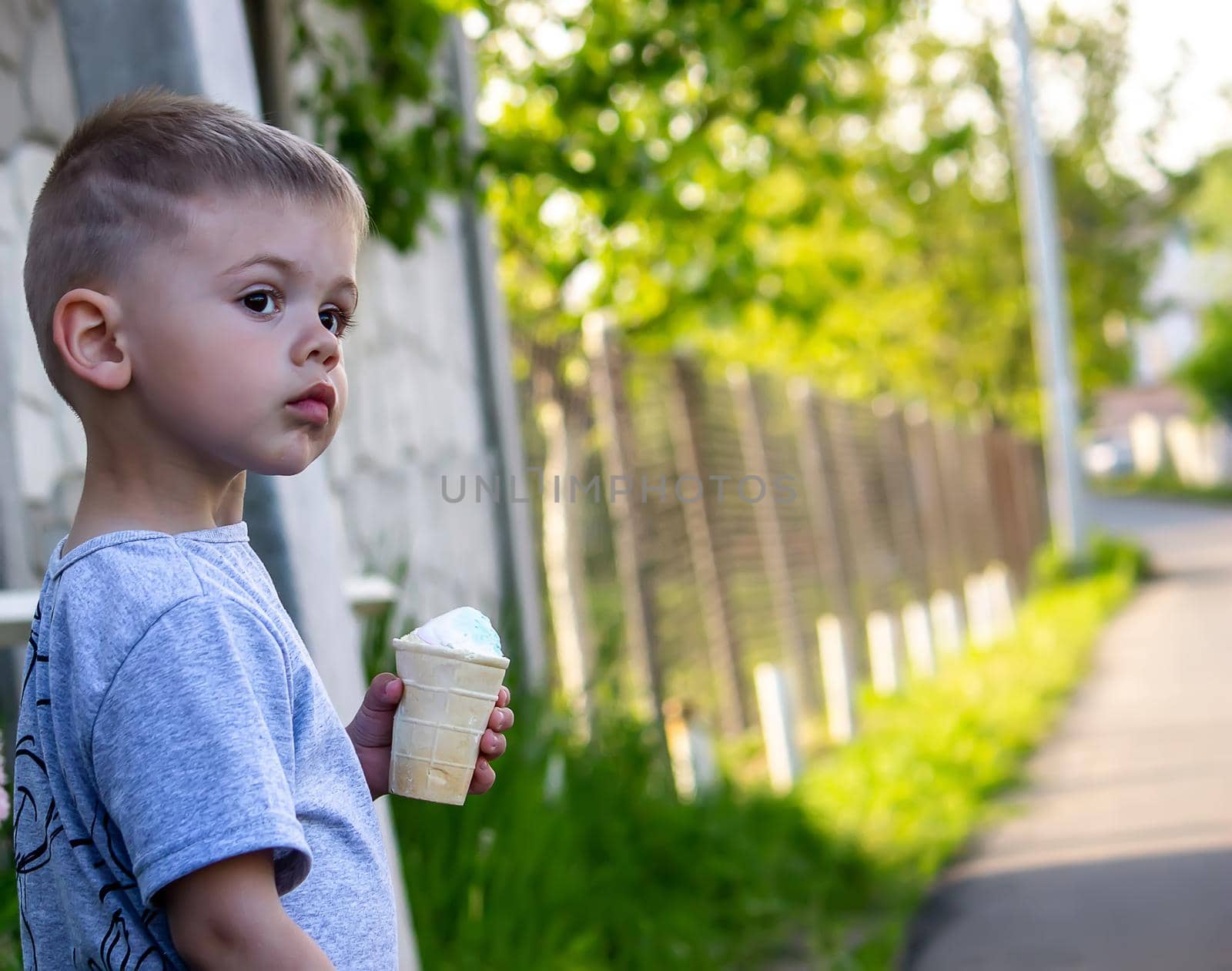 child eats ice cream in nature, ice cream in a cup. Nature. Selective focus