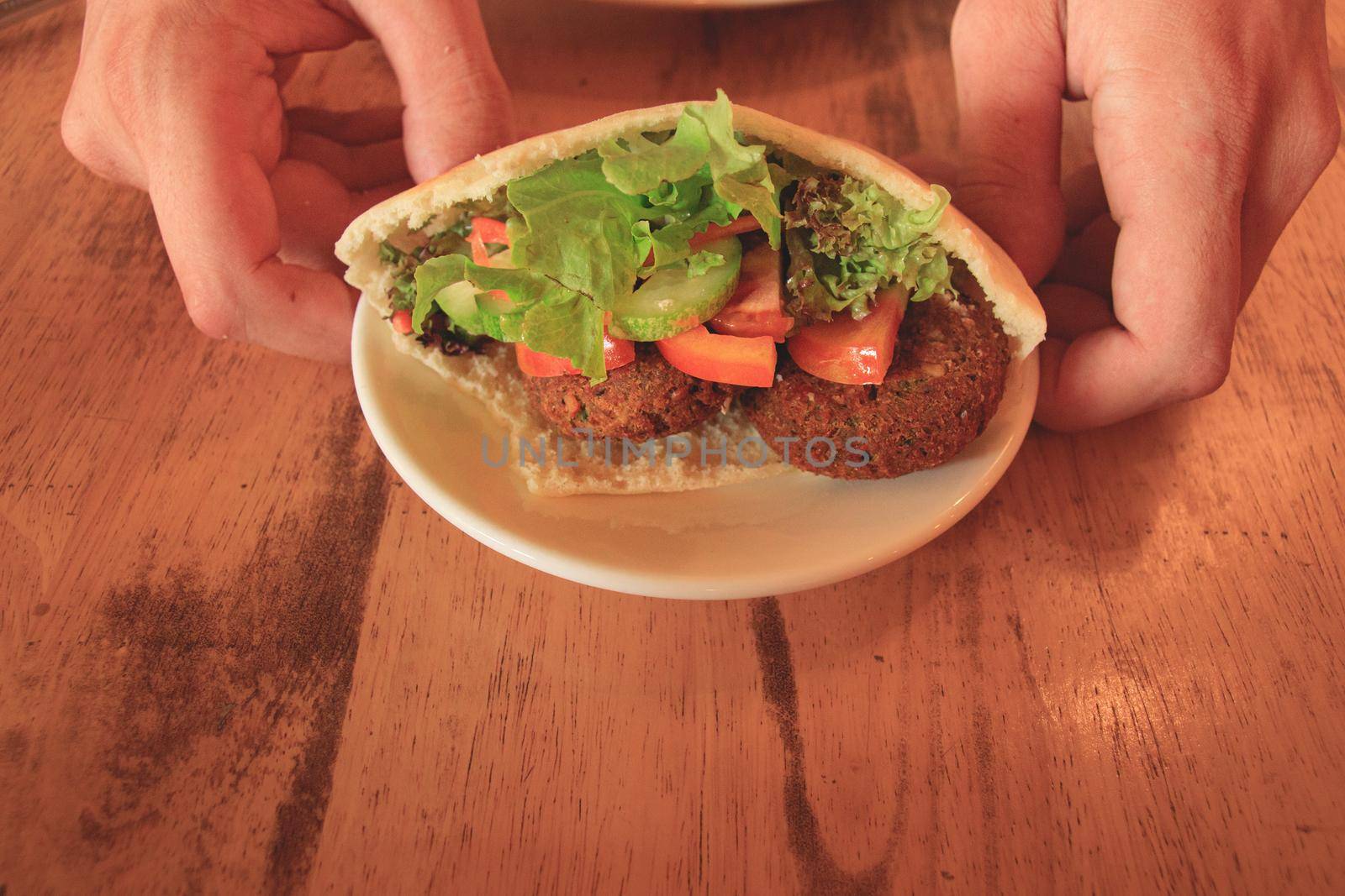 A serving of pita bread stuffed with falafel and fresh vegetable salad by Sonnet15