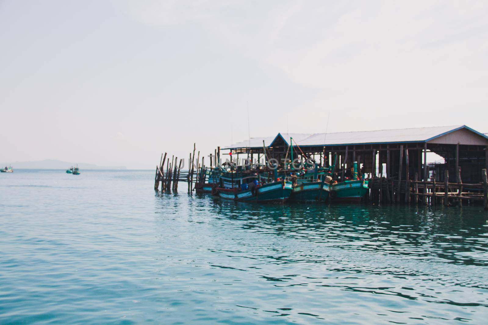 Minimalist scenery of the harbor against the blue sea and sky in Koh Sdach Island in Cambodia