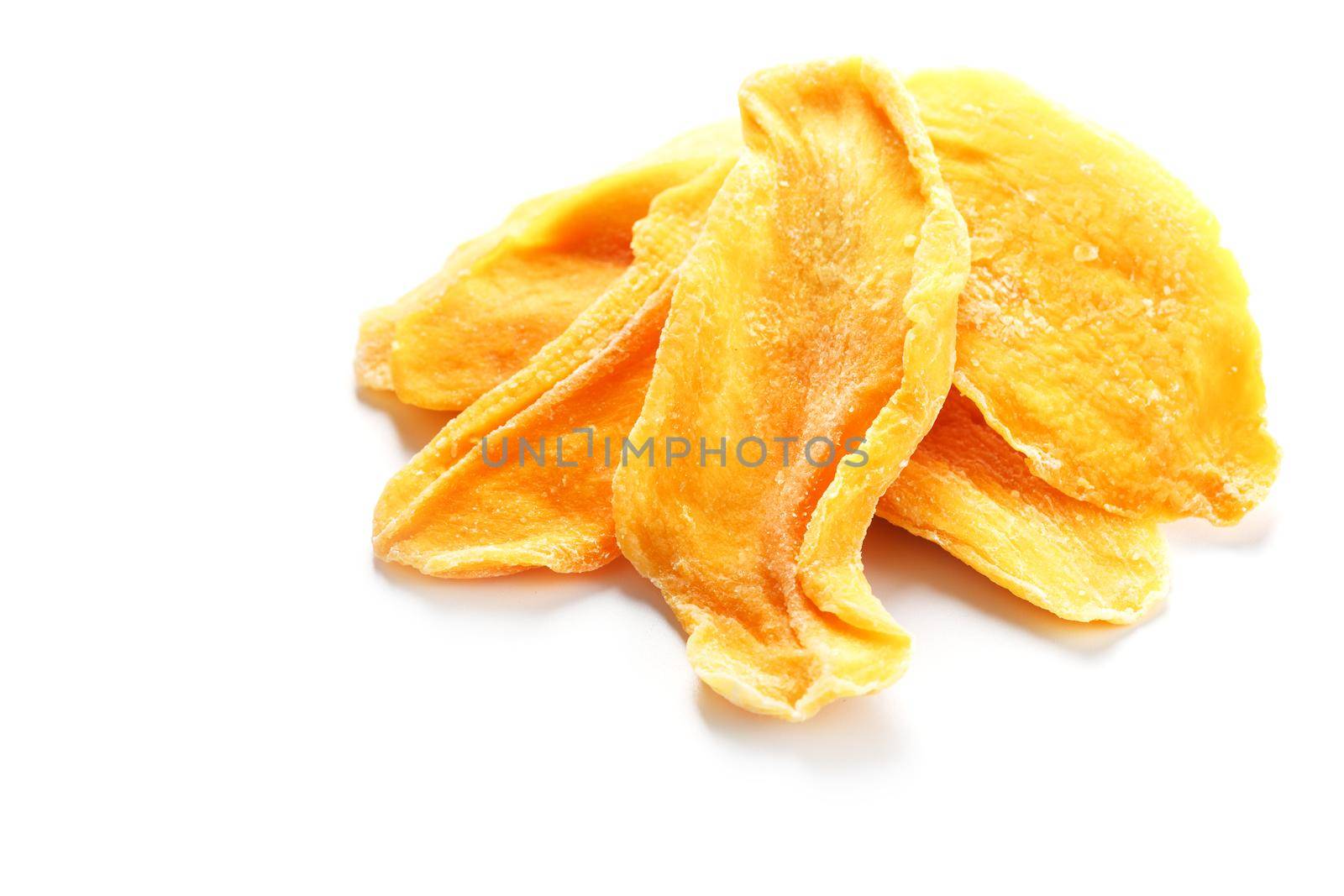 Dried sweet mango fruit slices as textural orange background in full screen