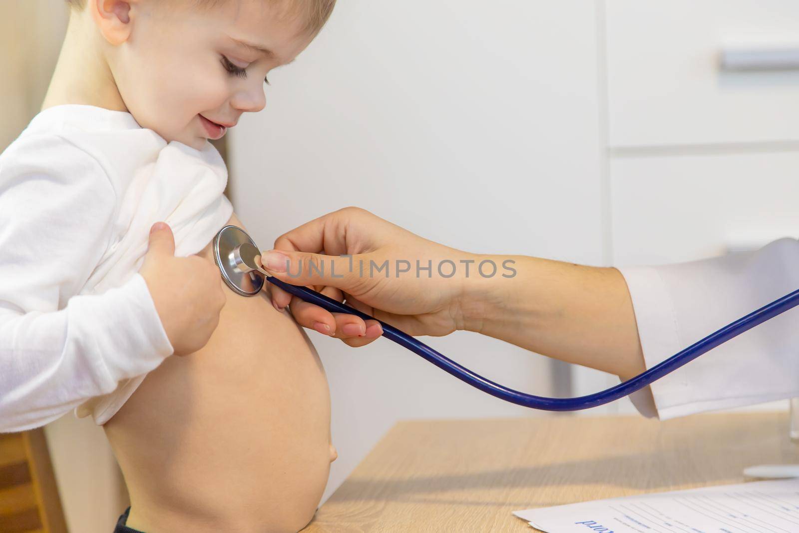 child being checked by a doctor. Selective focus