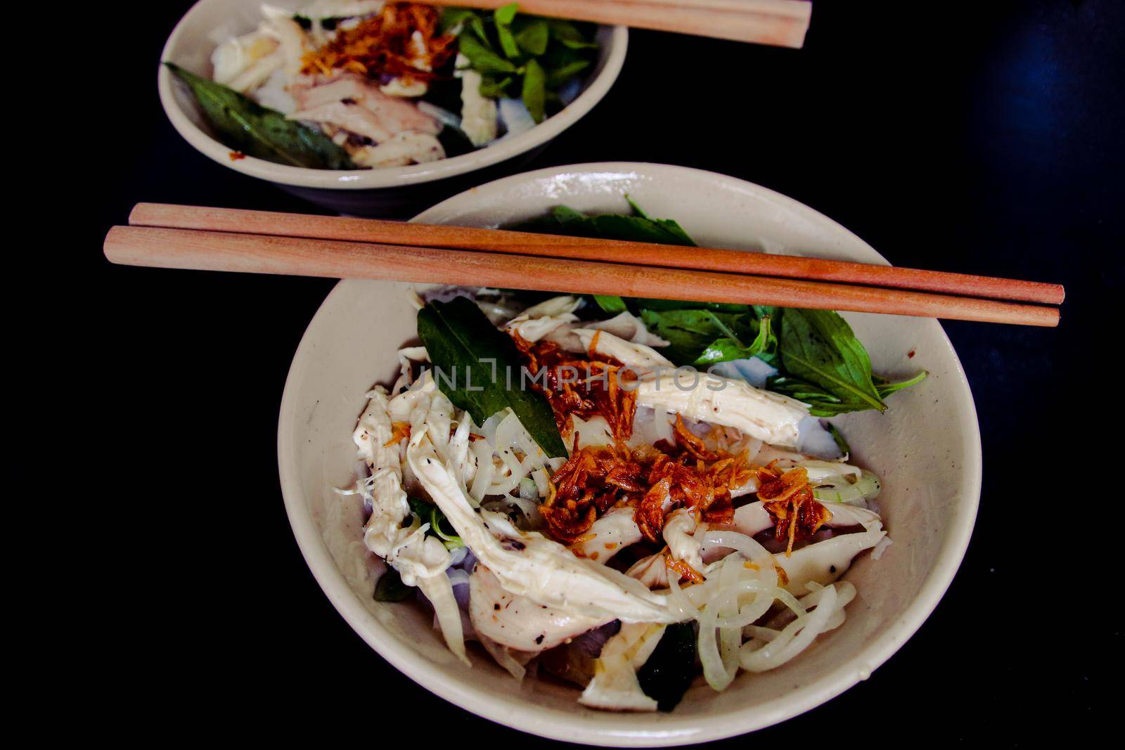 Banh Uot Long Ga, unique vietnamese dry rice noodles (flat and wide like wet rice cake noodle) dish mixed with herbs and meat, a local delicacy of Da lat Vietnam