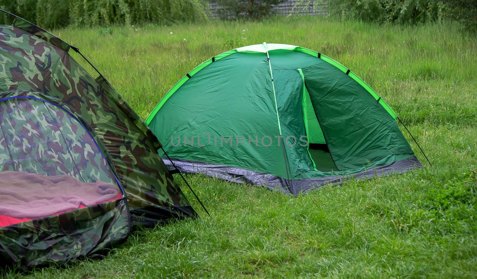 tourist tent, outdoor recreation near the river. Nature, recreation, camping Selective focus