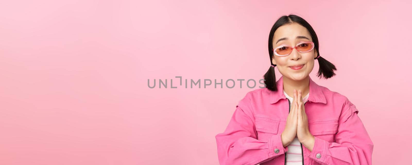 Please. Cute asian girl asking favour, begging, standing against studio background by Benzoix
