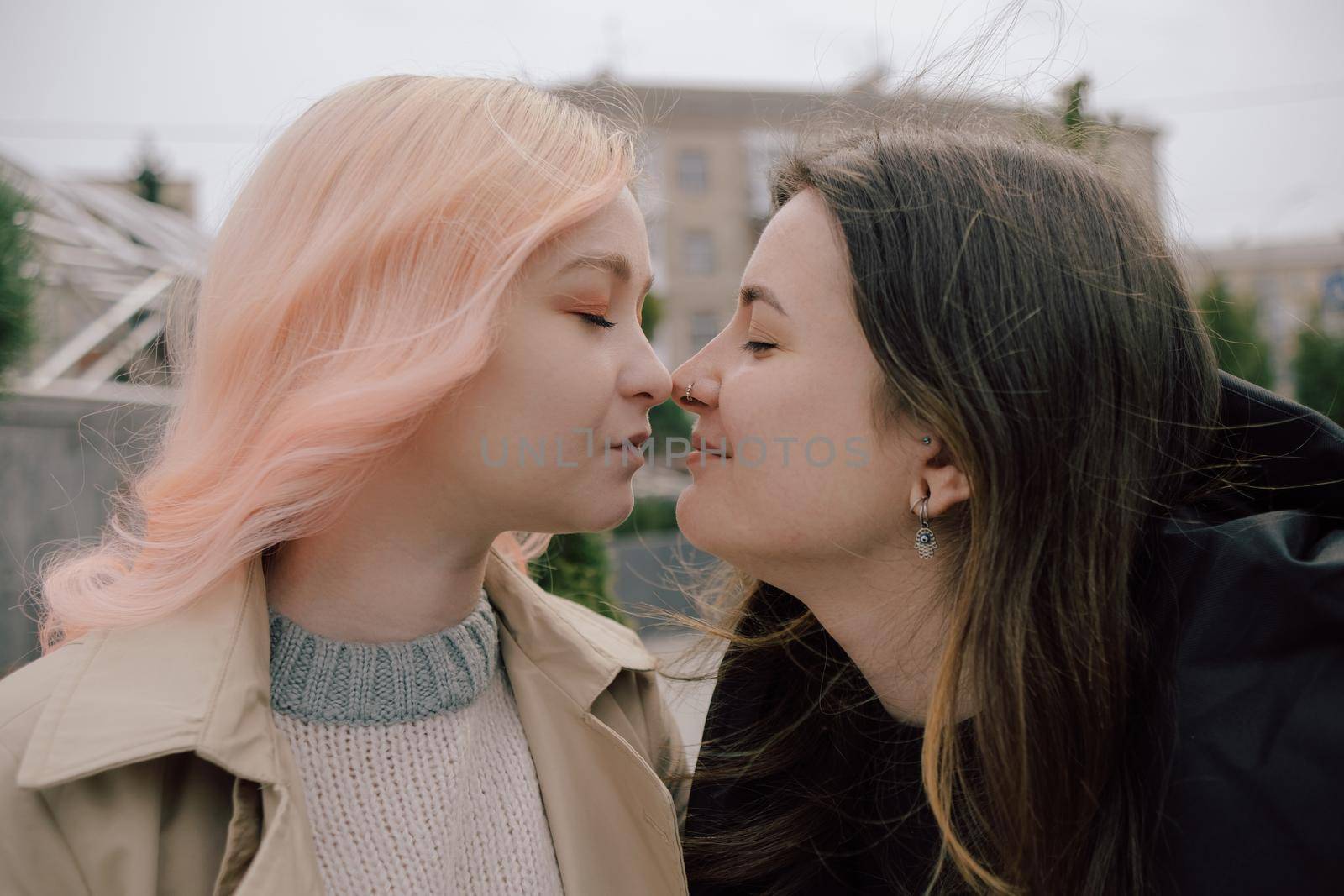 Happy young lesbian couple look on each other with love in their eyes by Symonenko