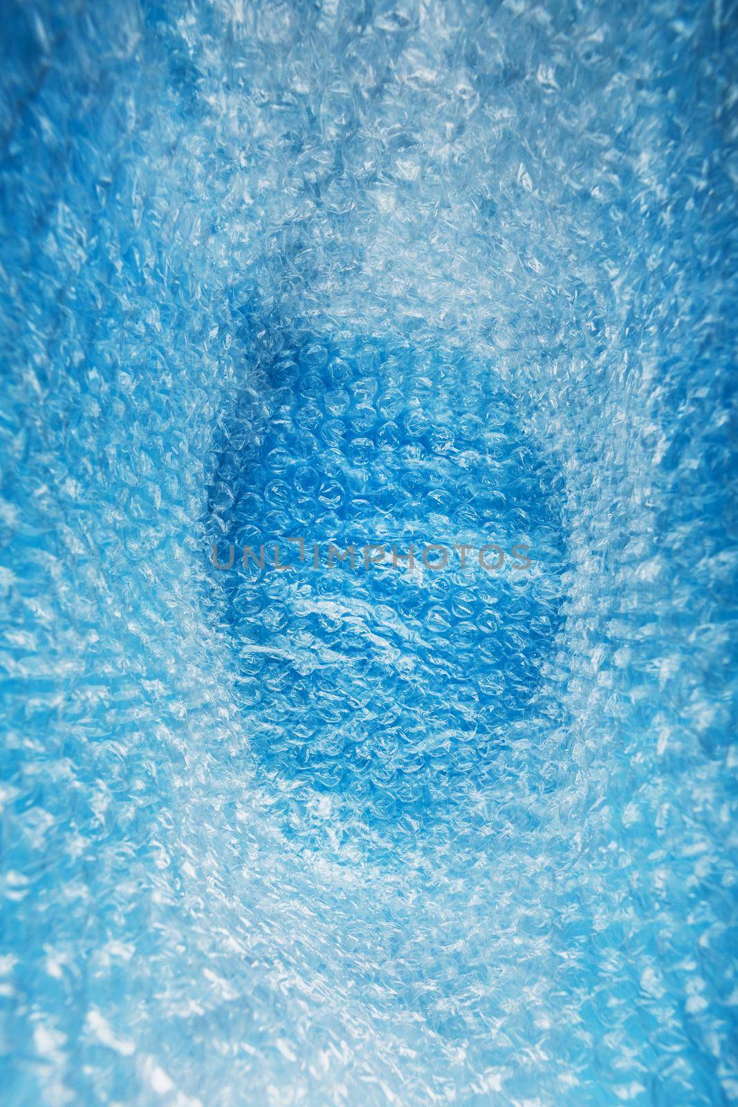 Inner space in a bag of packaging air-bubble film on a blue background in full screen by AlexGrec