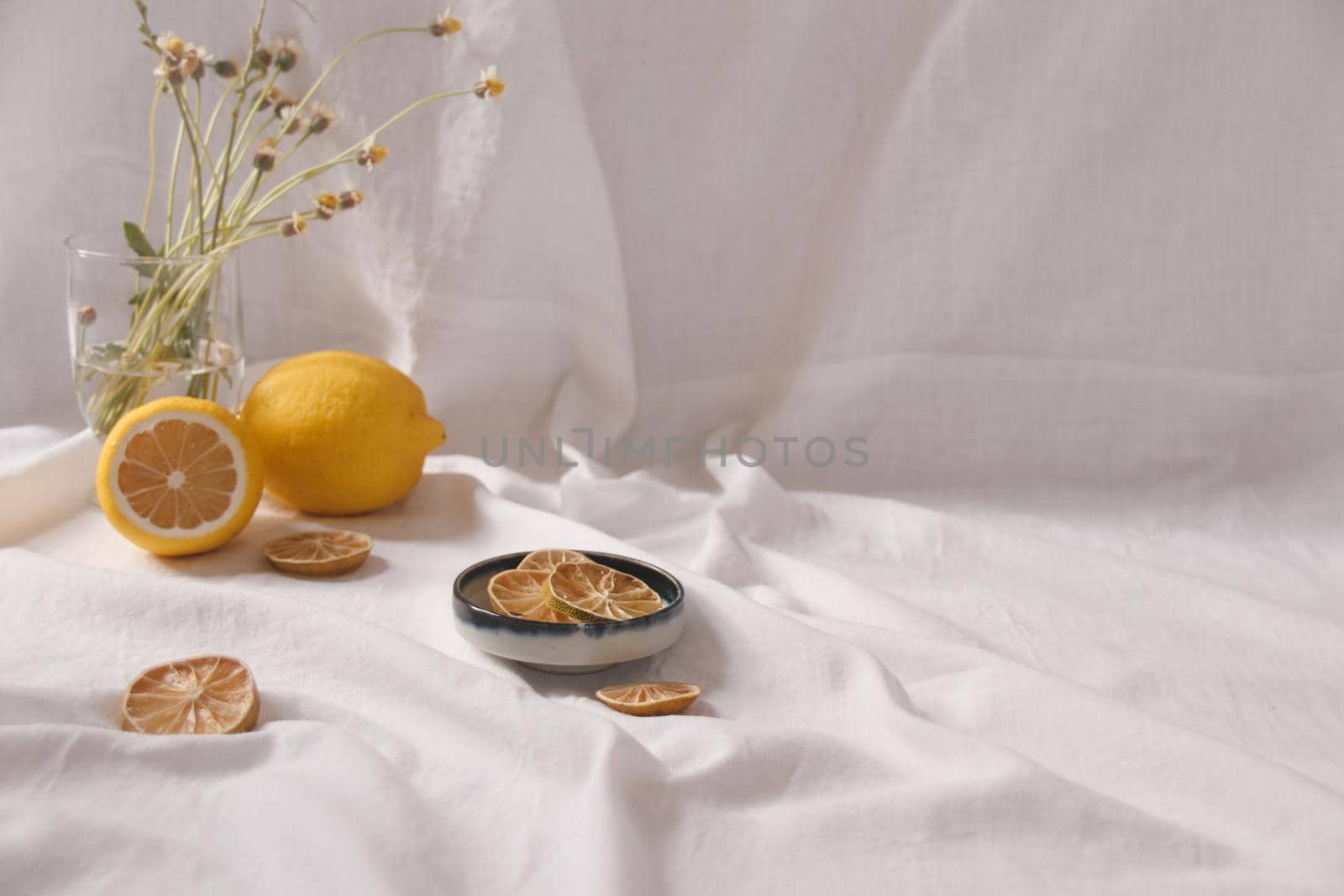 Minimalist still life of fresh and dried lemons showing the concept of freshness, summer aesthetic and healthy sustainable living