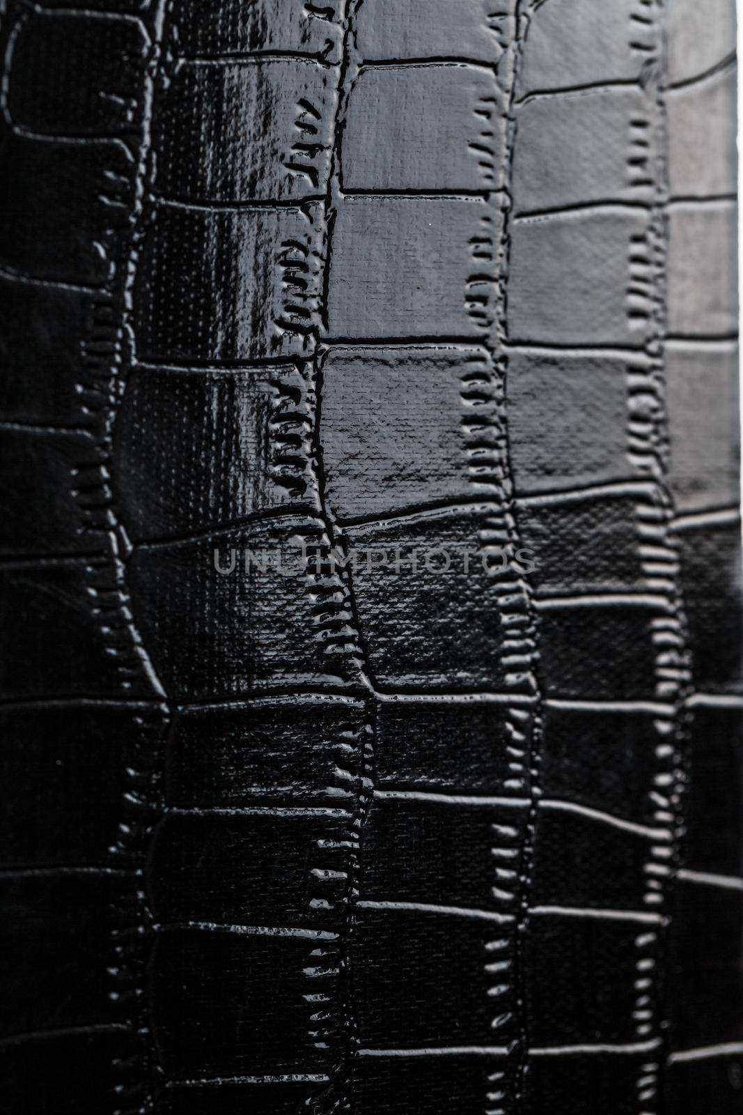 Black crocodile skin texture as background in full screen closeup