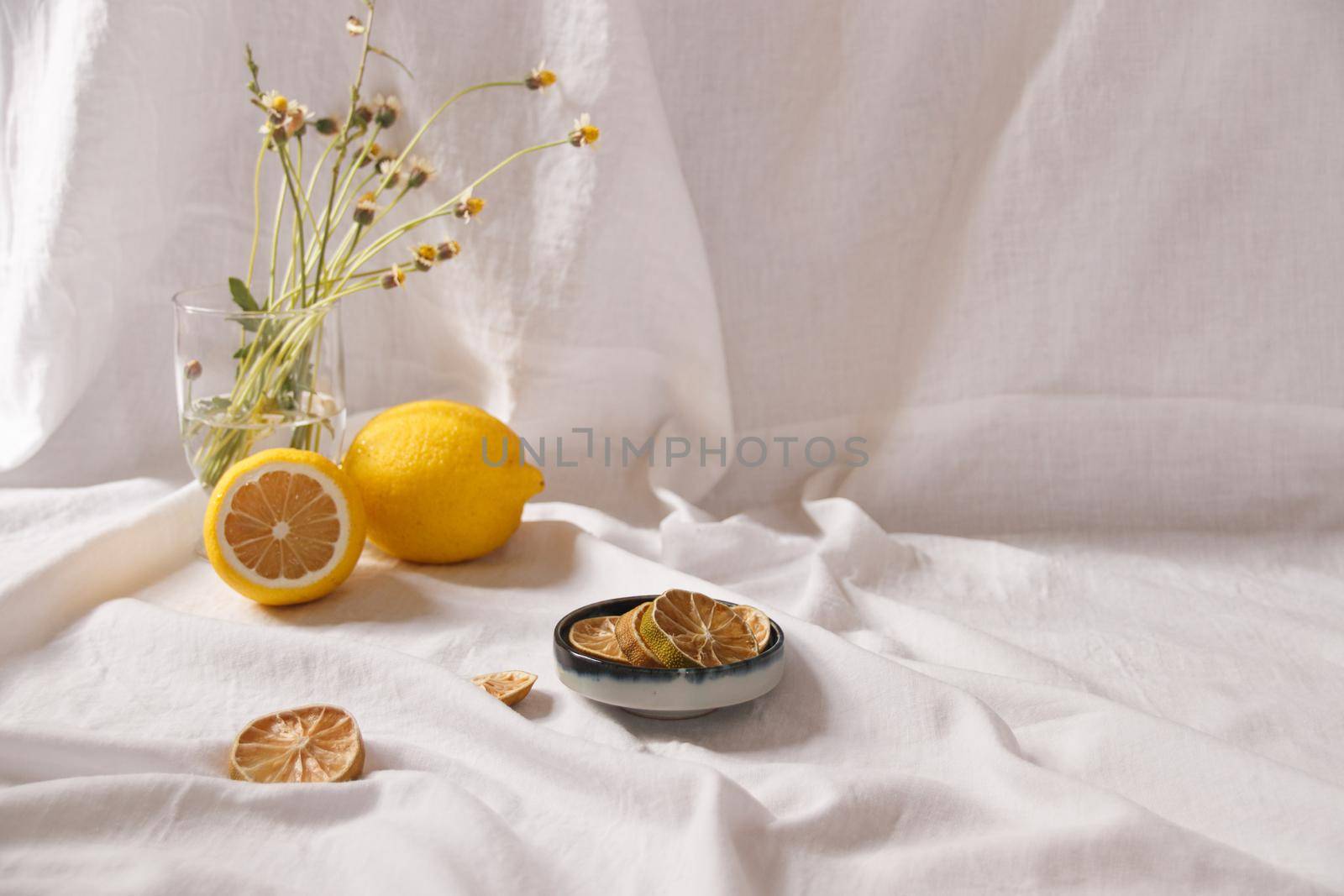 Minimalist still life of fresh and dried lemons showing the concept of freshness, summer aesthetic and healthy sustainable living