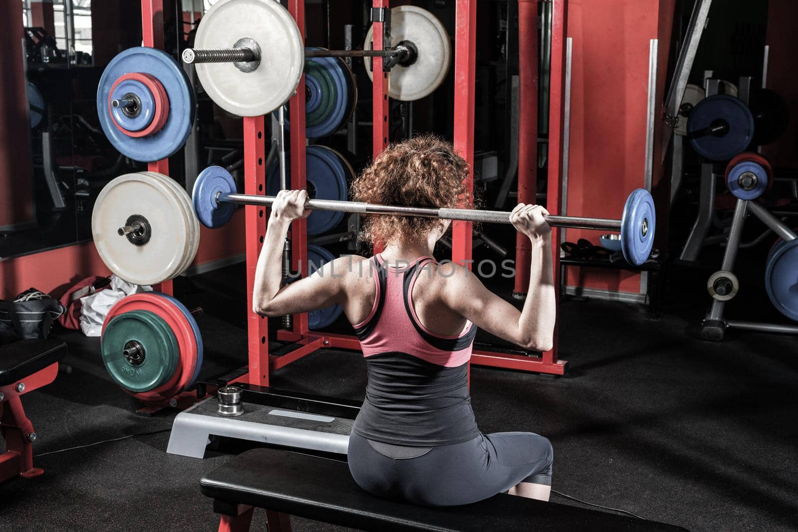 Woman bodybuilder engaged with a barbell in the gym. Healthy lifestyle.