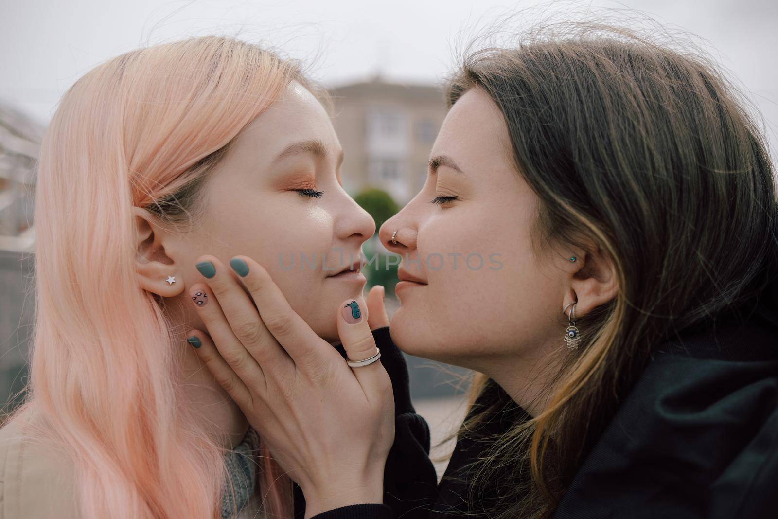 Happy young lesbian couple look on each other with love in their eyes by Symonenko