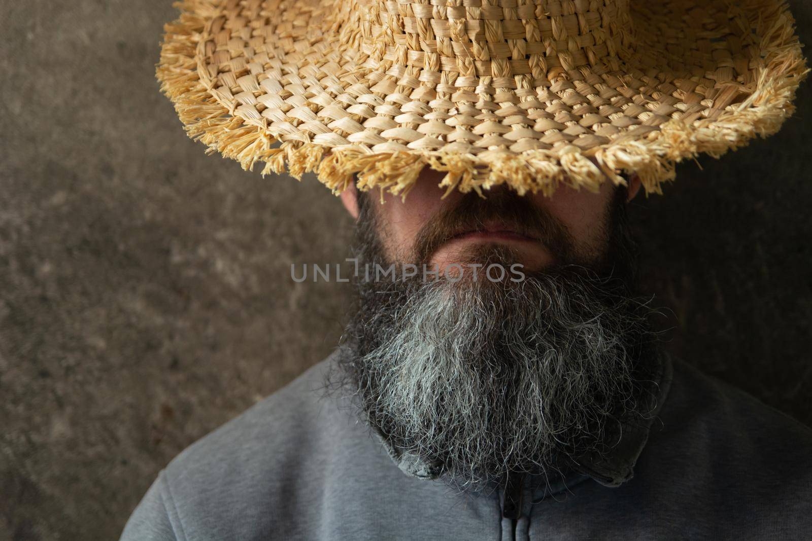 A napping man with a long beard in a hat, male portrait