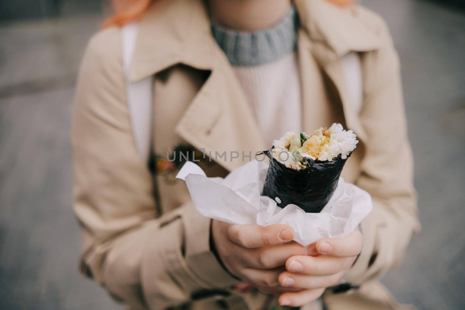 a woman holds shawarma in her hands. fast food. a simple and delicious snack. grilling.
