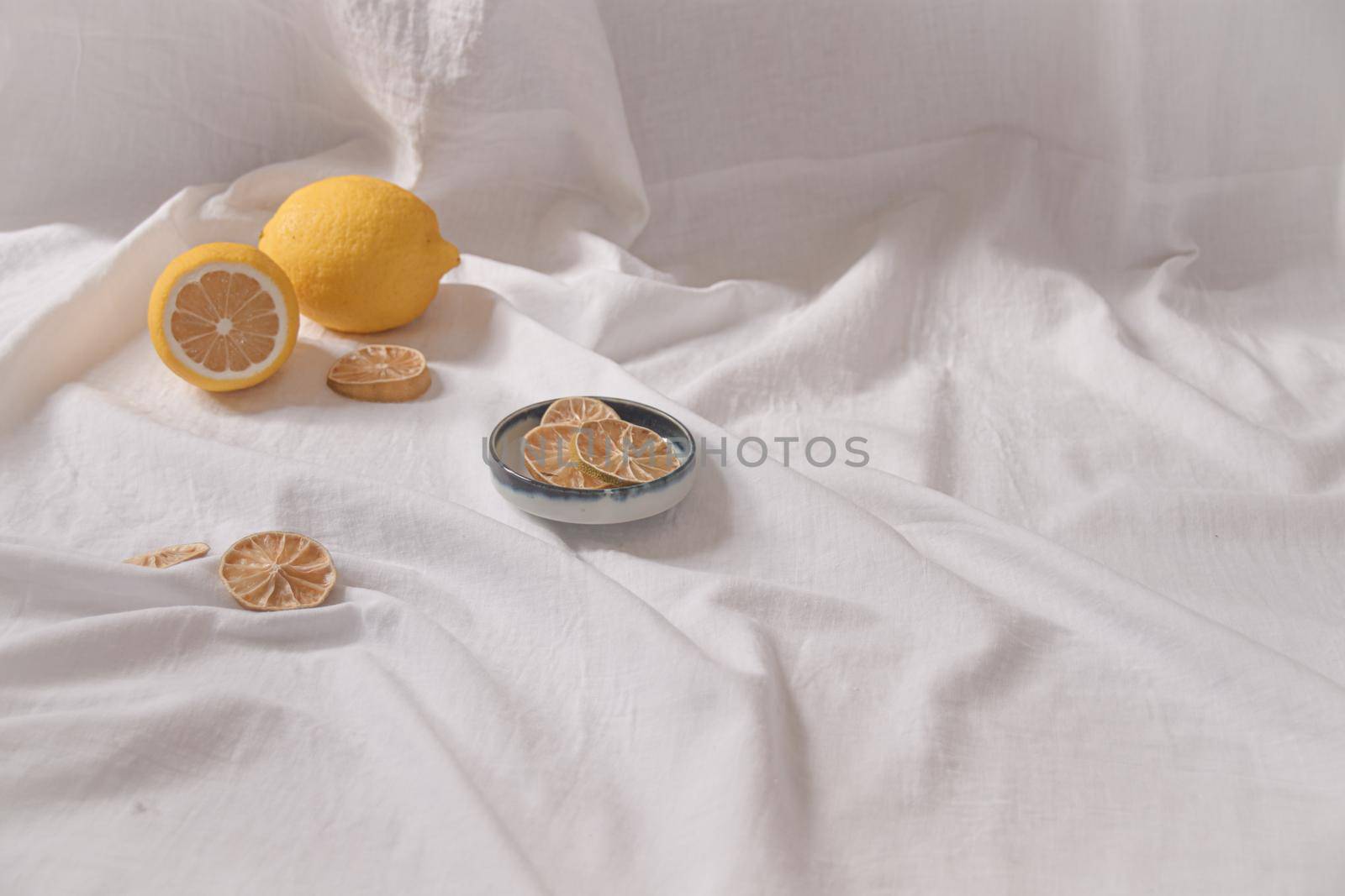 Minimalist still life of fresh and dried lemons showing the concept of freshness, summer aesthetic and healthy sustainable living