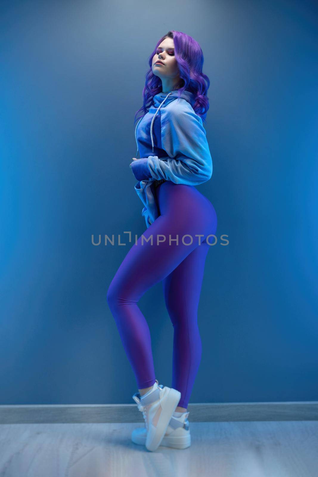 a girl in stylish purple sportswear and with purple hair poses sexually by Rotozey