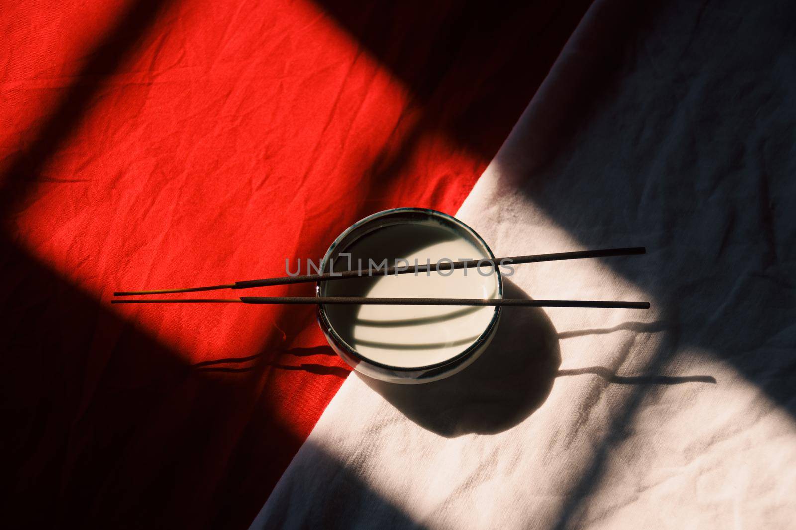Light and shadows cast on a ceramic incense holder and sticks by Sonnet15
