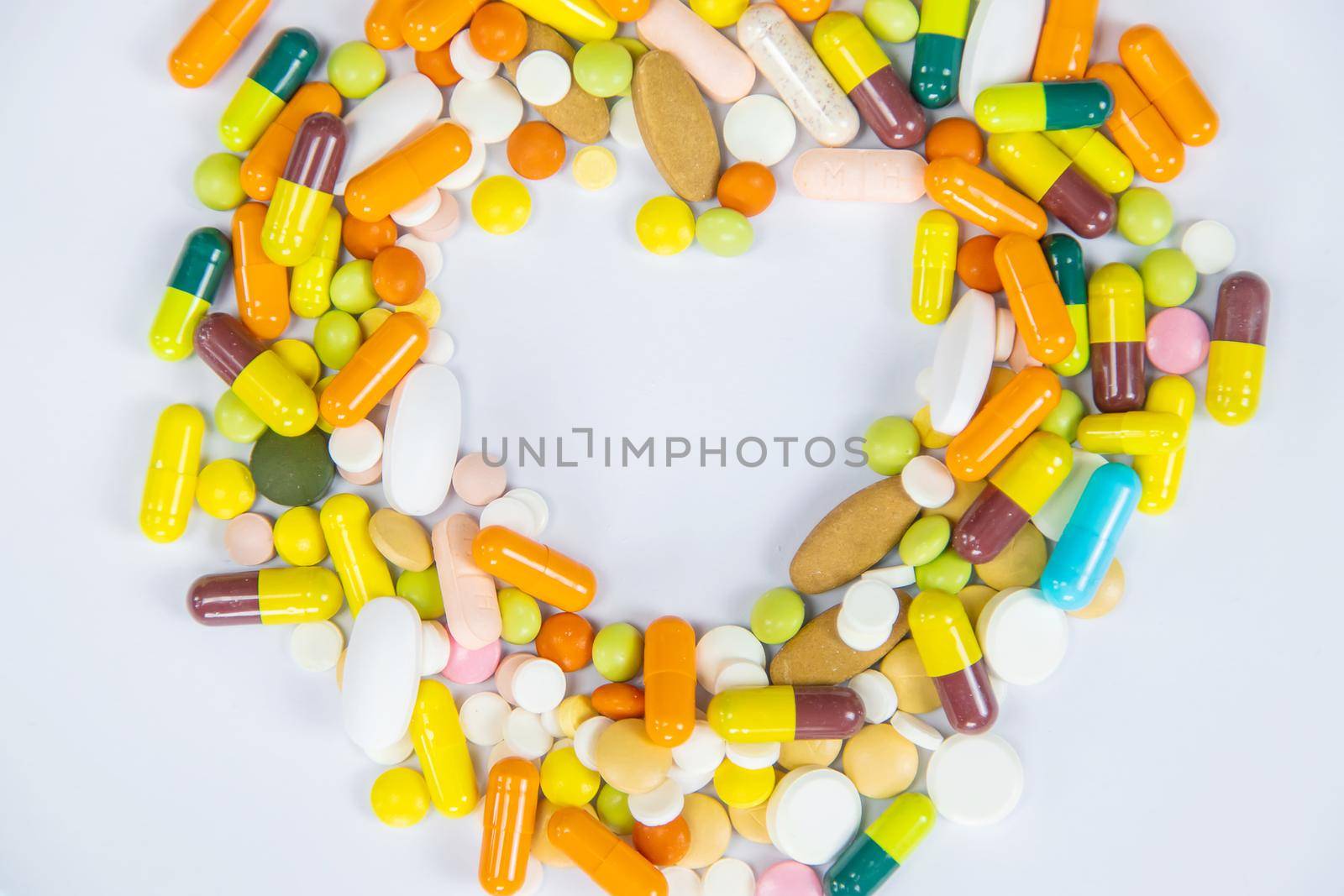 medical supplies on a yellow background, pills water treatment mask virus.