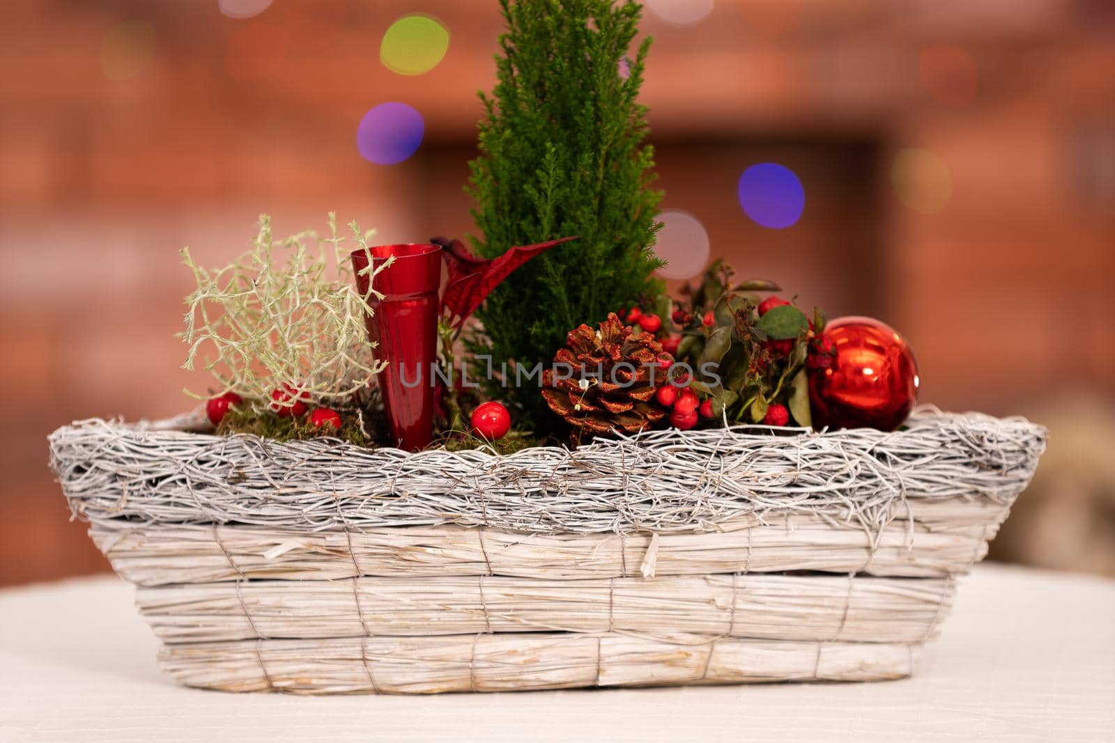 The close up frame shows a Christmas reed prepared to celebrate the ongoing Christmas season. In the distance you can see a blurred background with a fireplace