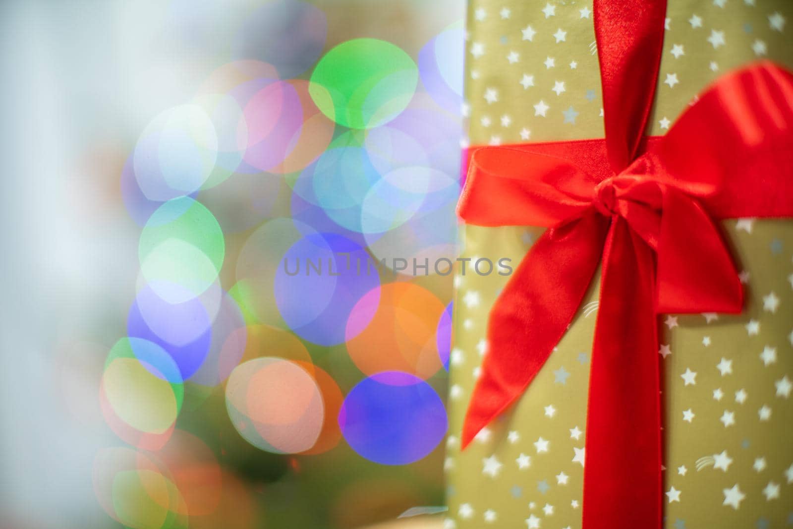 A decorative box with a Christmas gift in the background with cork lights.