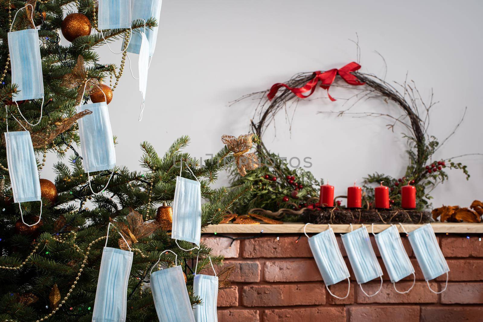 A Christmas tree in the foreground and a decorated fireplace in the second. Unusual Christmas.