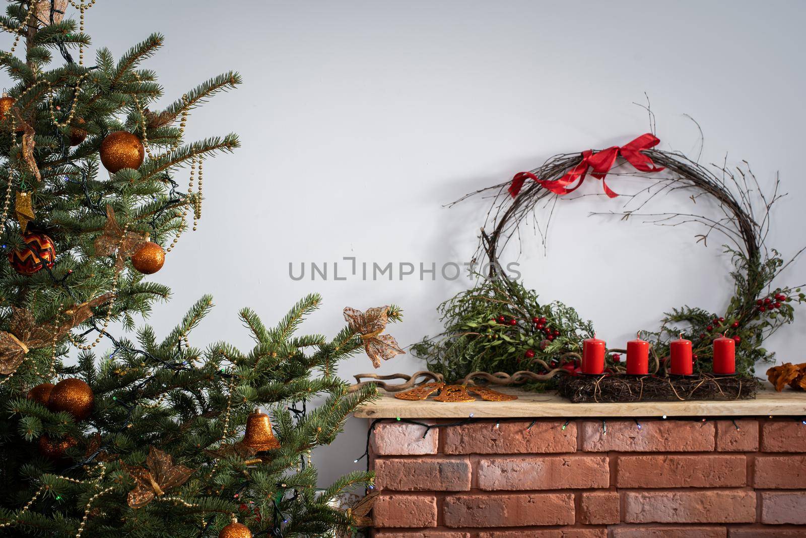 A Christmas tree in the foreground and a decorated fireplace in the second. Unusual Christmas.