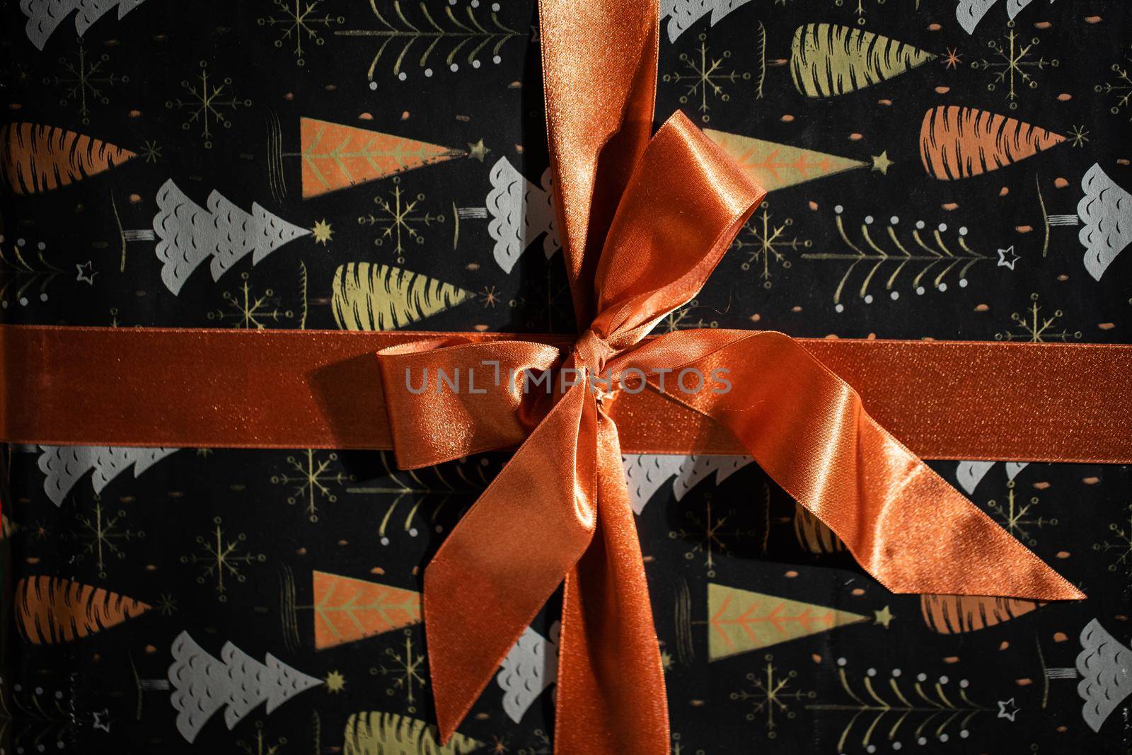 Prepared for giving a gift with a beautiful golden bow for a husband or wife on Christmas Day. Gift wrapped.