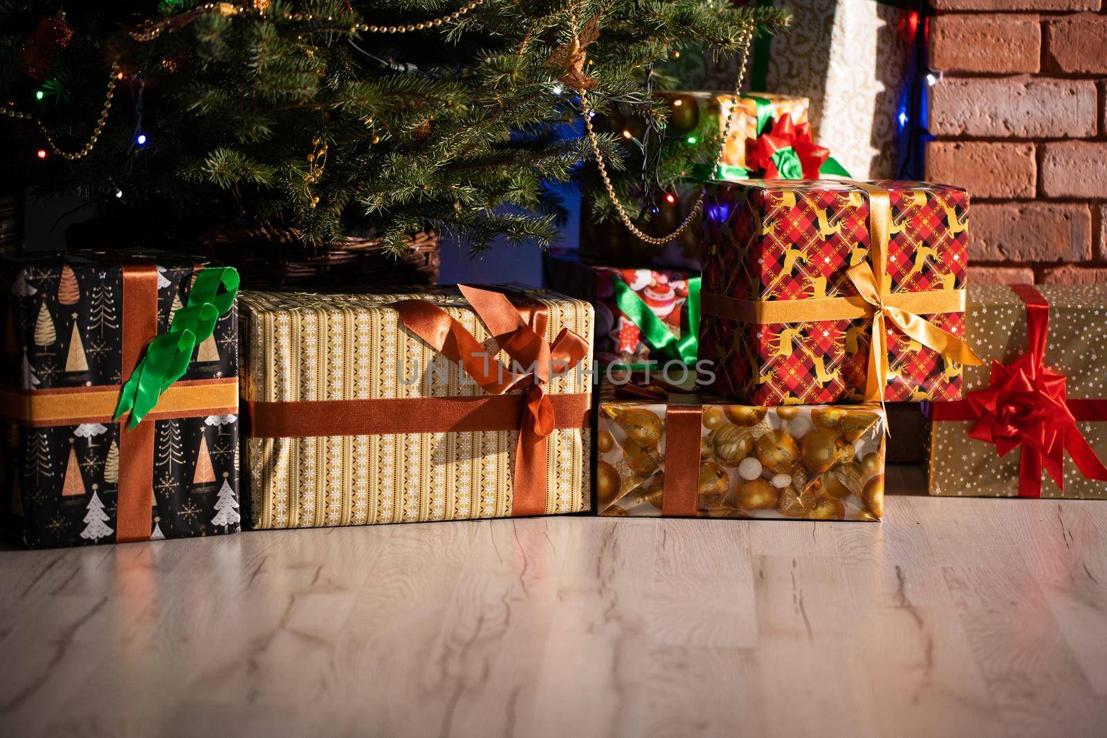 A Christmas tree in the foreground and a decorated fireplace in the second. Unusual Christmas.