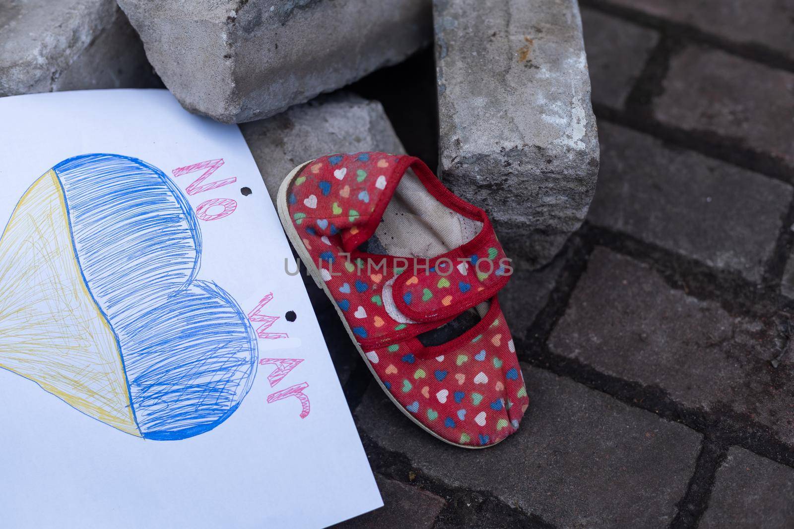 children's shoes and the flag of Ukraine, the war.