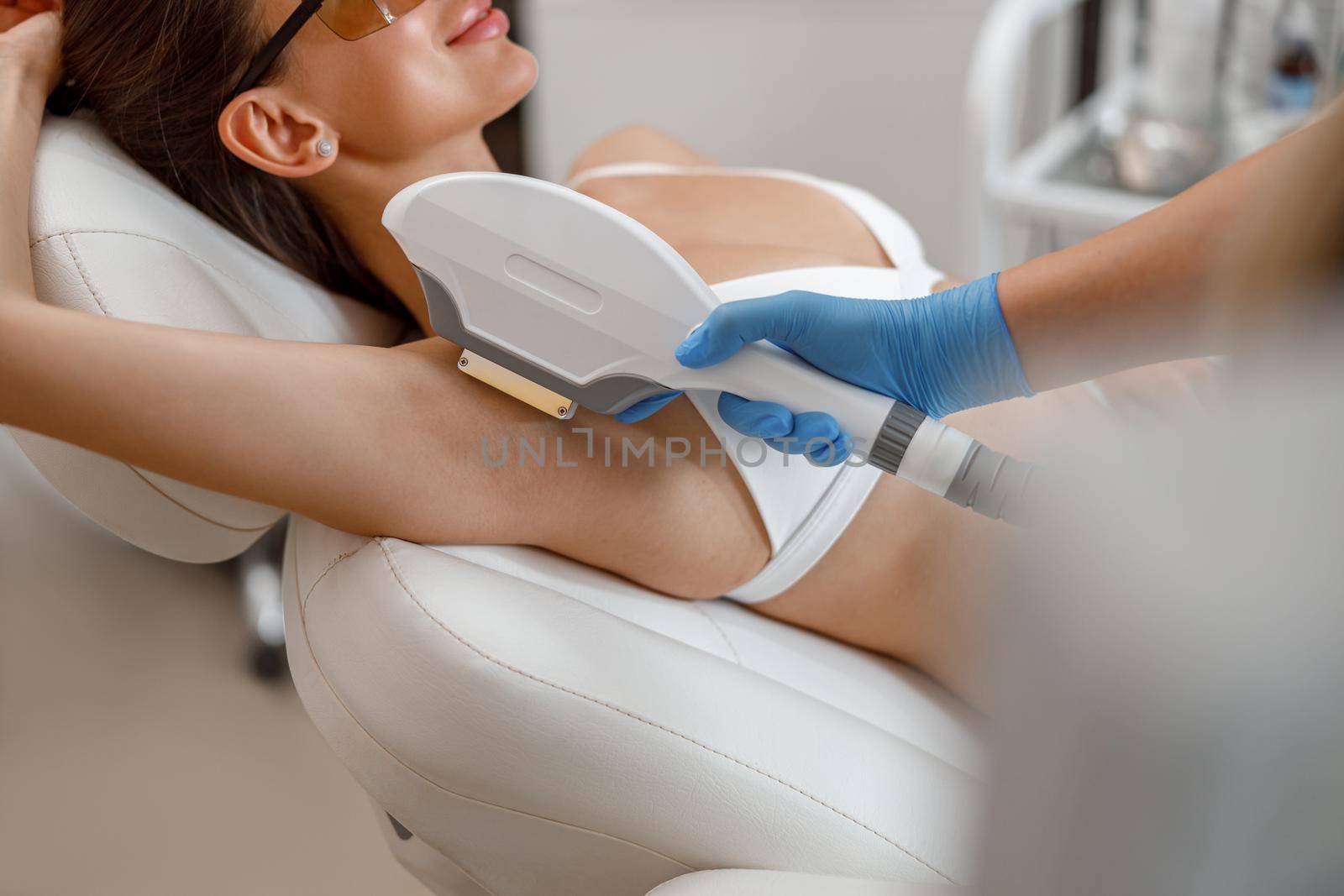 Armpit hair photo epilation procedure with ipl machine in a beauty salon. Cosmetology