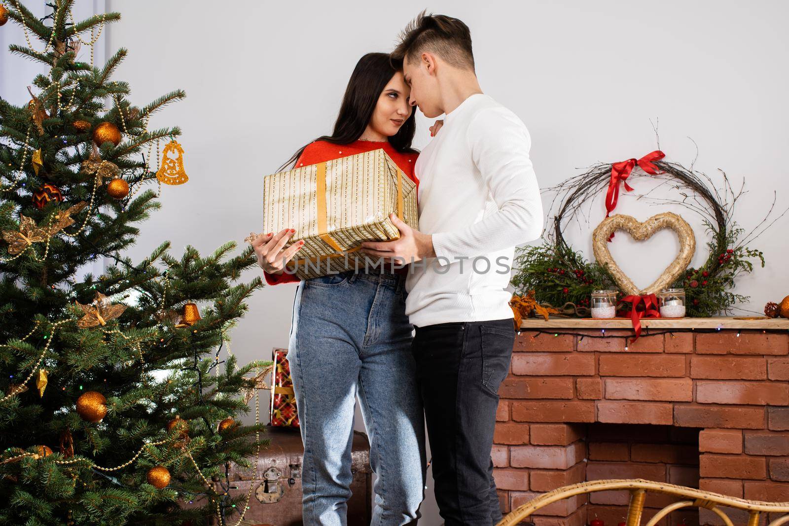 An unexpected gift from the fiancee while decorating the Christmas tree for Christmas. December Christian holidays.