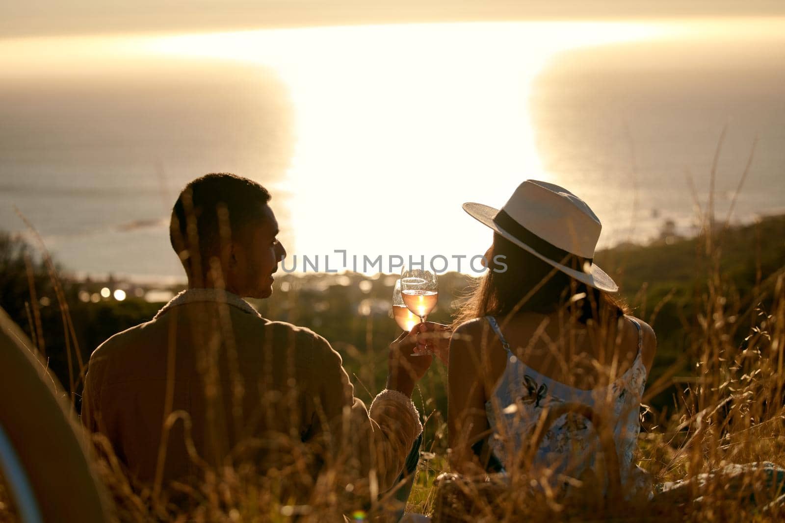 Shot of a young couple enjoying the sunset outside in nature.