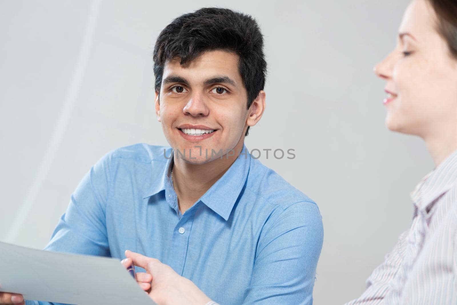 portrait of a young man at a business meeting. concept of team work