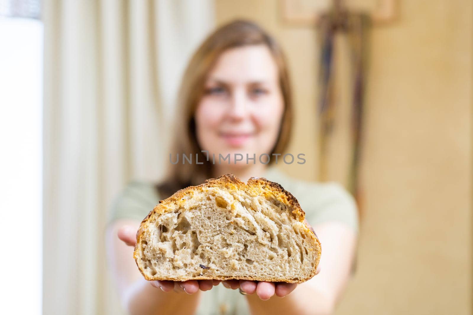 commercial shots, a girl baked bread, she cuts it with a knife, breaks it with her hands, sniffs it, it smells wonderful. association with childhood and parental home.