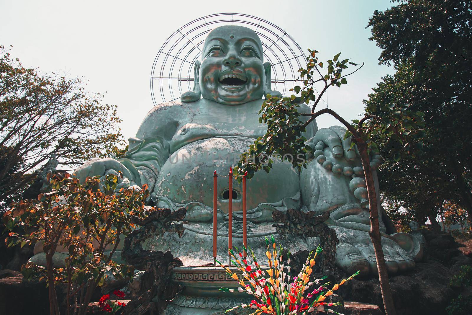 Low angle view of a giant Smiling Buddha Statue in Linh An Pagoda in Da lat, Vietnam