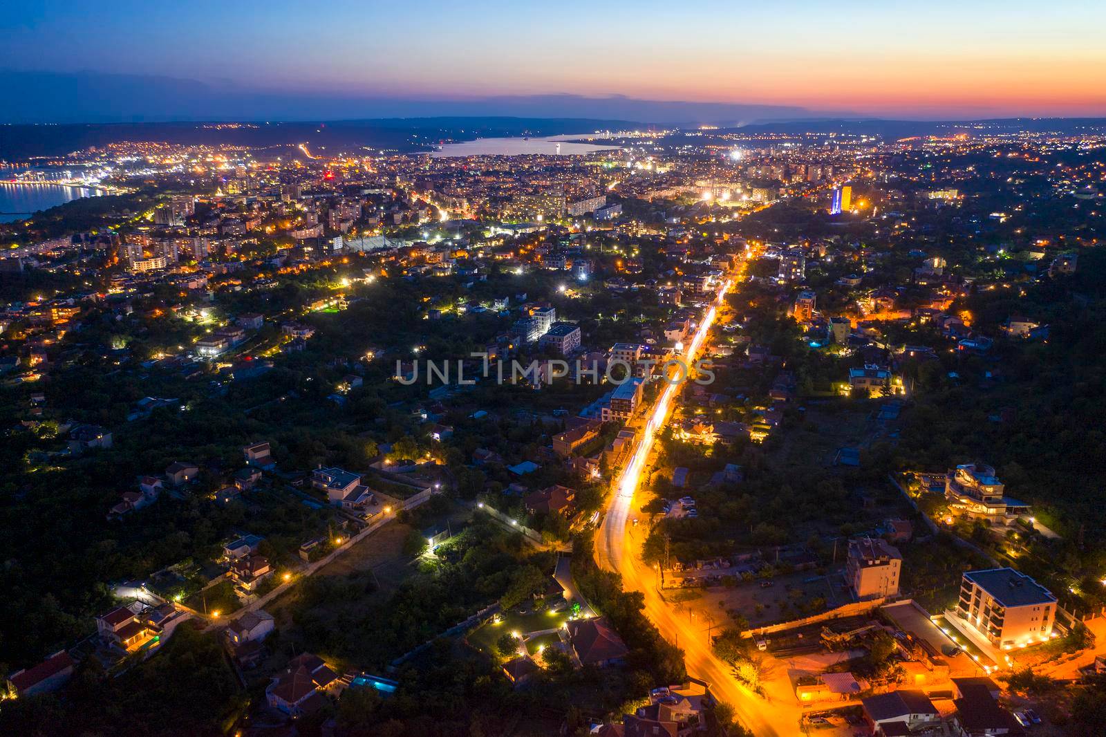 Aerial view from the drone of the illuminated city at twilight. Varna, Bulgaria