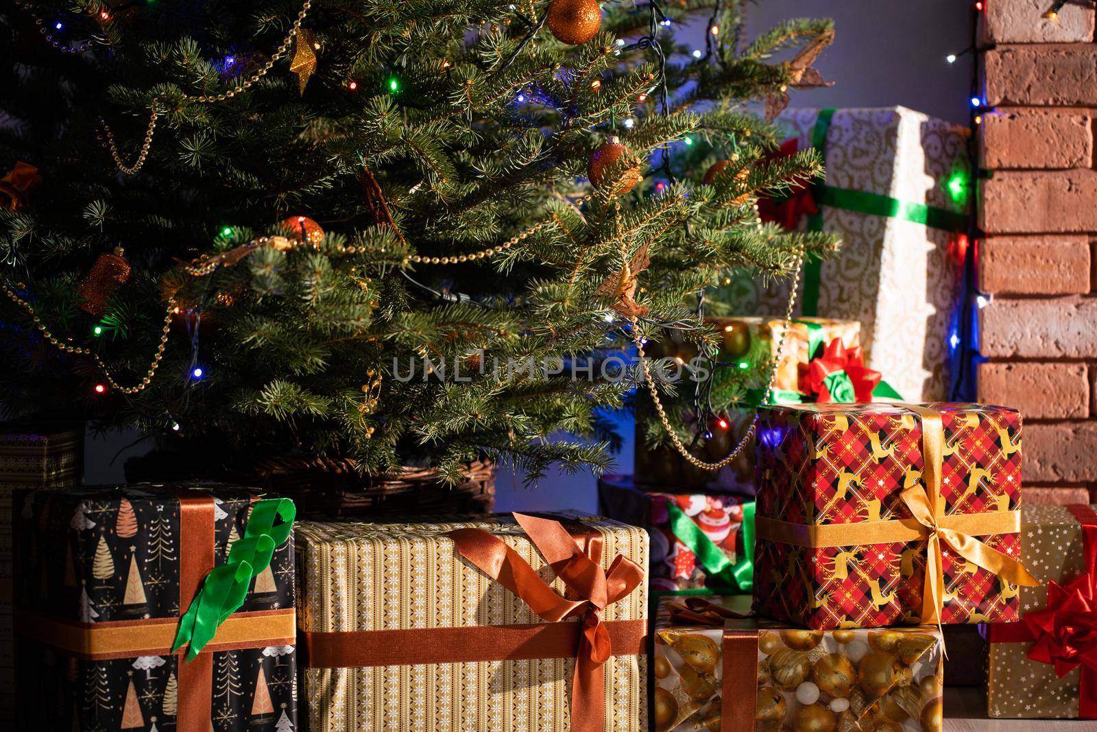 A Christmas tree in the foreground and a decorated fireplace in the second. Unusual Christmas.