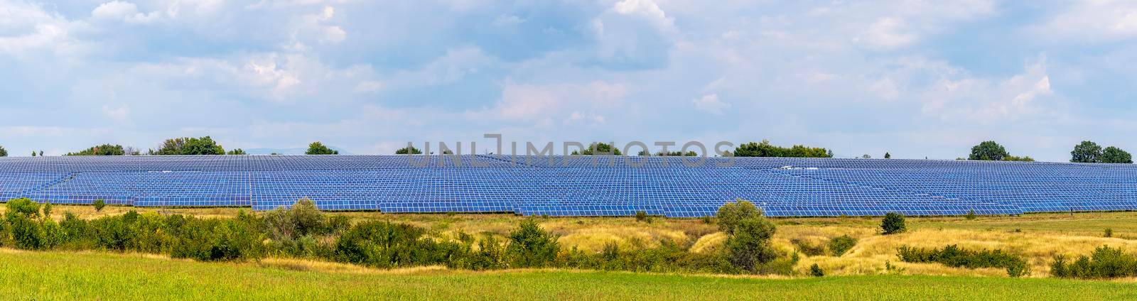 Banner of solar panels at hills against the sky. Industry concept