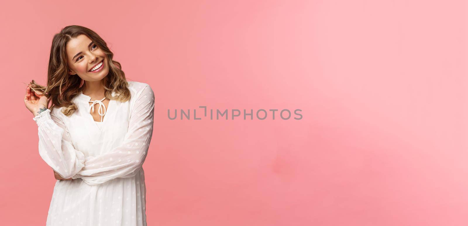 Feminine, beautiful and coquettish young blond woman in stylish white sping dress, giggle silly look away at right side, rolling curl on hair strand flirting with someone over pink background by Benzoix