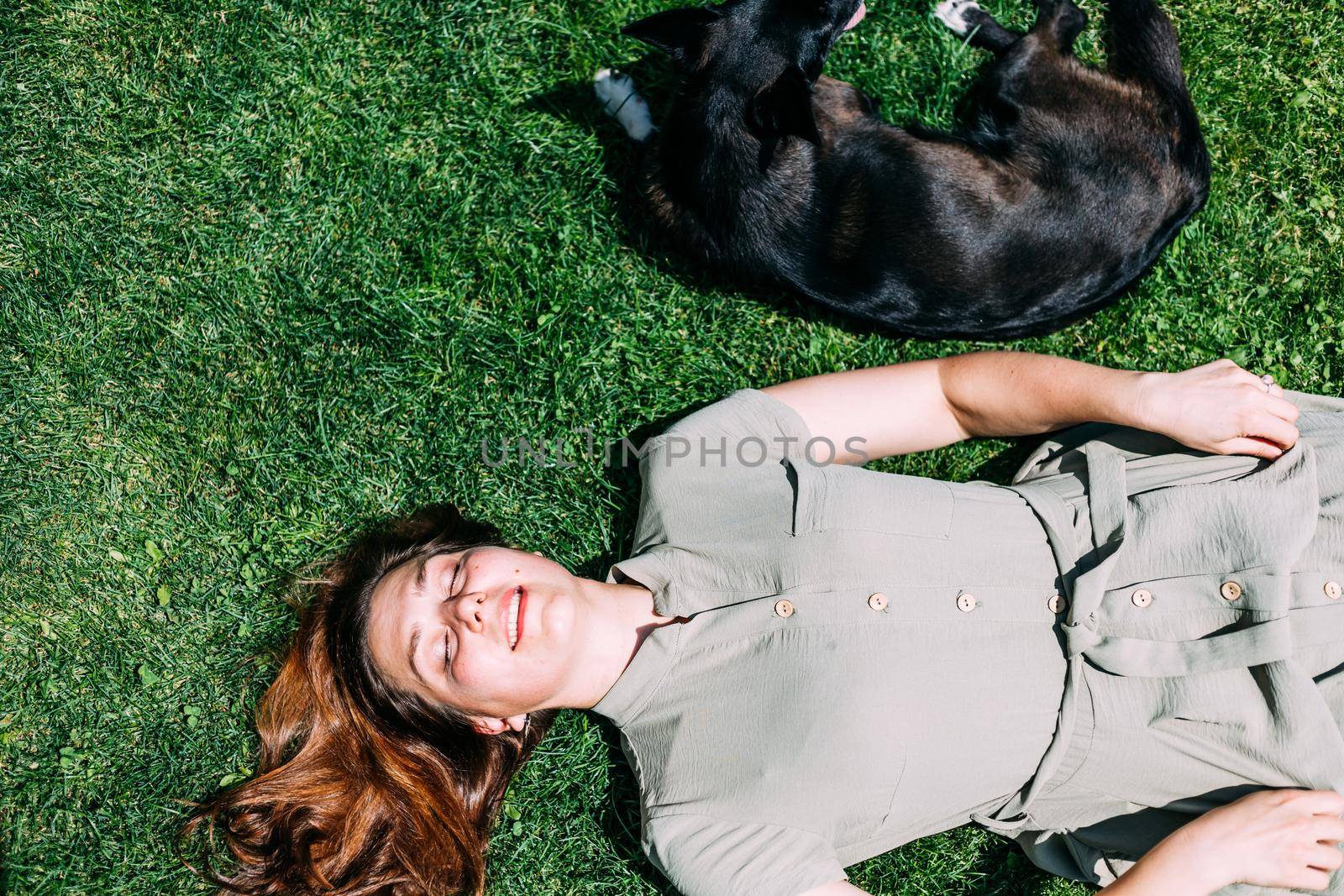 a young girl in the summer plays on the lawn with a dog, she scratches it while she licks and enjoys. Prores422. by mosfet_ua